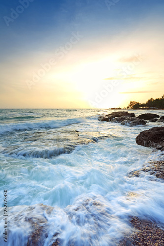 Sea waves lash line impact rock on the beach with during the beautiful sunset  Eastern of Thailand 