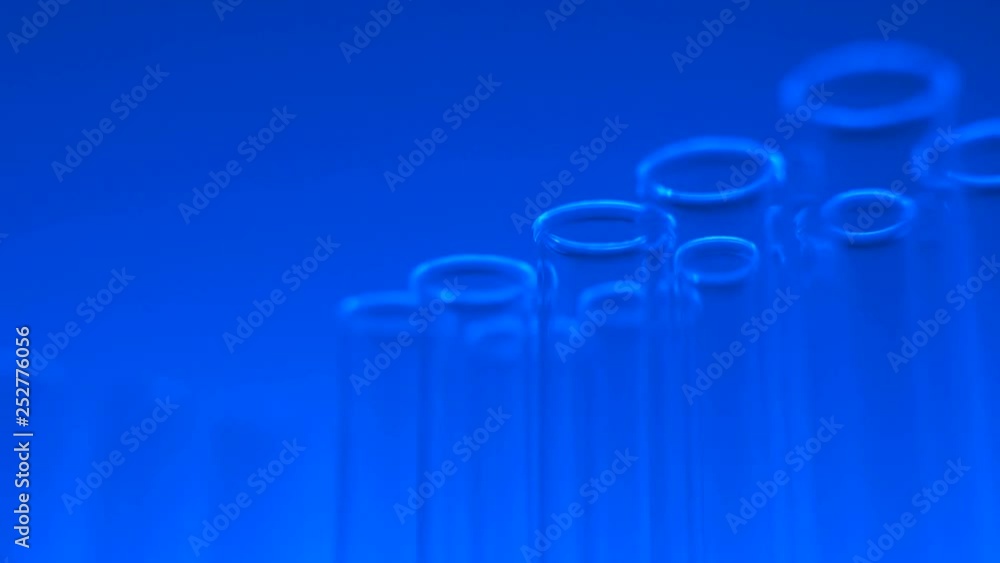Glass test tubes in laboratory with blue light. Close up 4K footage. Glass test tubes in laboratory with blue light. Close up 4K footage.