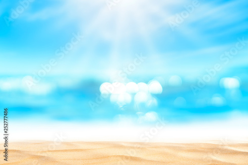 Blur tropical beach with bokeh sun light wave abstract background.