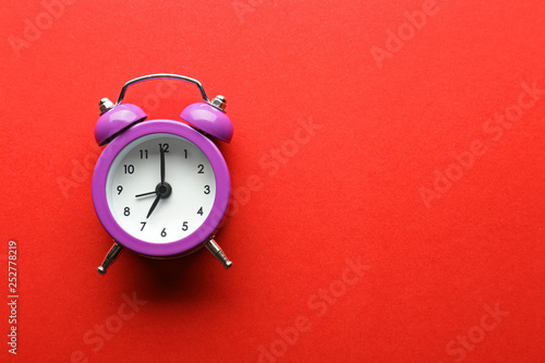 Alarm clock on color background