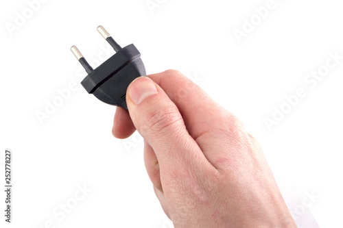 electric plug in hand on white background