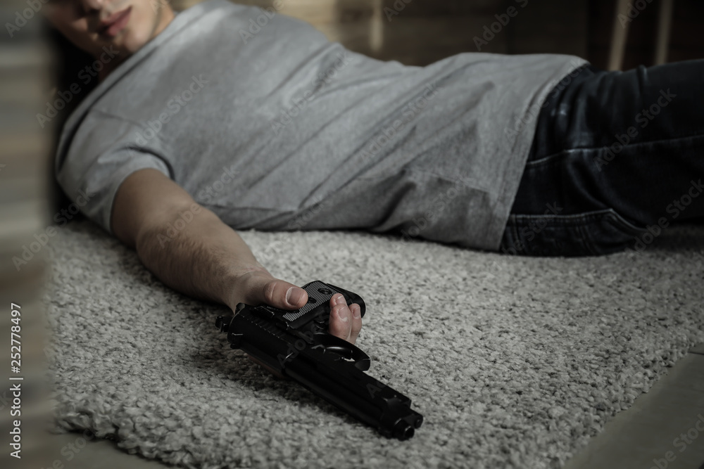 Body of man with gun after committing suicide lying on floor Stock Photo |  Adobe Stock