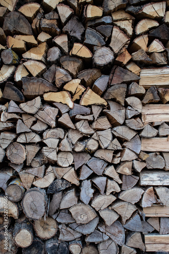 Wall of firewood  neatly stacked  in italian country house