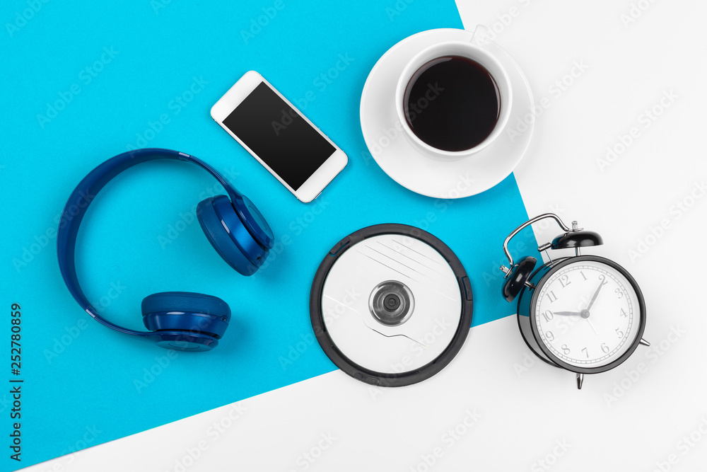Blue headphones on blue and white color background - obrazy, fototapety, plakaty 
