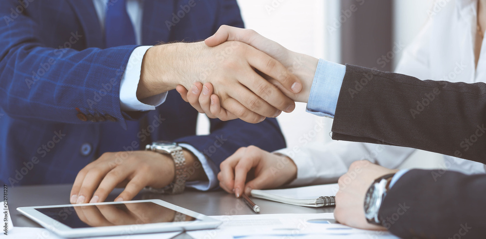 Obraz premium Business people shaking hands, finishing up a papers signing. Meeting, agreement and lawyer consulting concept