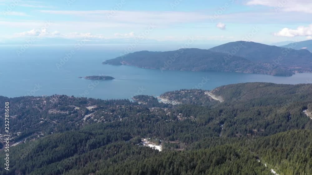 Aerial view over Burrard Inlet, ocean and island with mountains in beautiful British Columbia. Canada. 4K. Aerial view over Burrard Inlet, ocean and island with mountains in beautiful British Columbia. Canada. 4K.