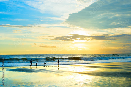 Family walking sunset beach Bali