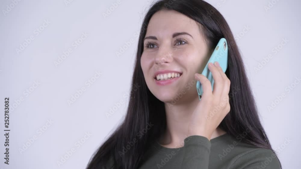 Face of happy young beautiful woman talking on the phone