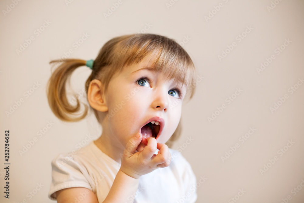 funny two years old girl with two cute pigtails, quiff and open mouth funny two years old girl with two cute pigtails, quiff and open mouth