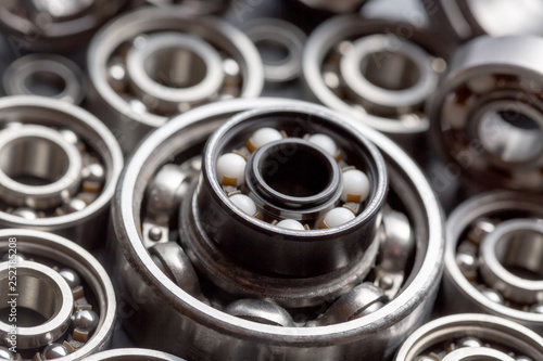 Machinery and technology industrial background. Group of various ball bearings close up.