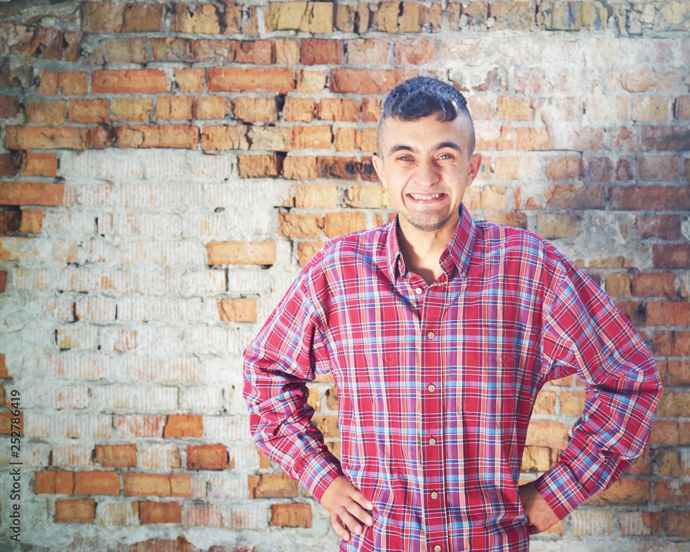 portrait of young man in front of brick wall portrait of young man in front of brick wall