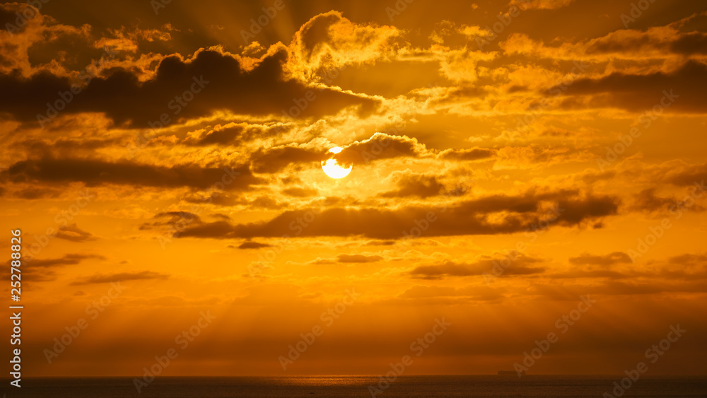 Beatiful sunset above the mediterranean sea with yellow sky and the sun shining