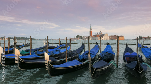 gondolas tied up at piazza san marco, venice with san giorgio maggiore