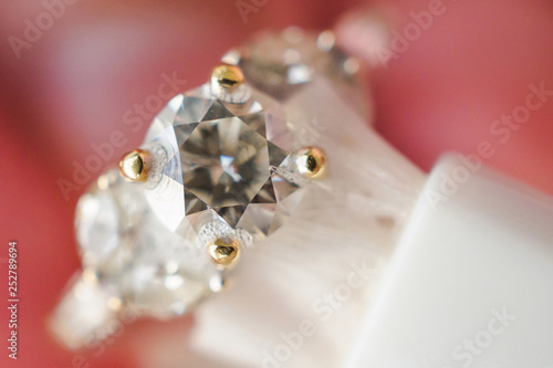 Jeweller hand cleaning and polishing vintage jewelry diamond ring closeup macro