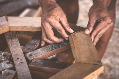 close up carpenter working with hand tool 