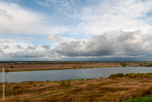 Rural landscape near the Konstantinovo village with clouded skies and meadows and hills