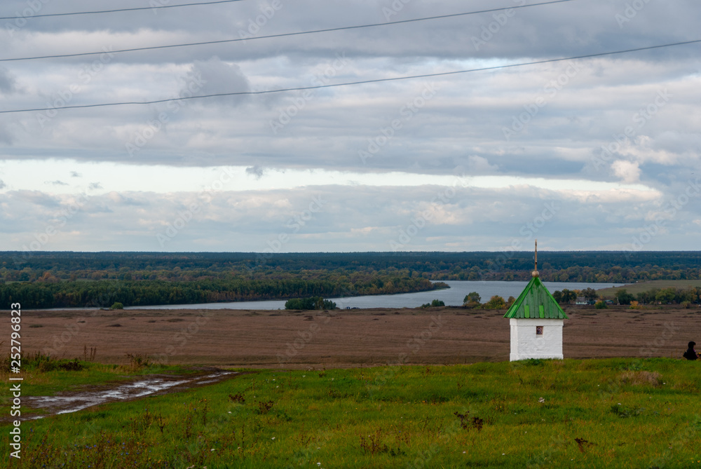 Fototapeta premium Rural landscape near the Konstantinovo village with clouded skies and meadows and hills