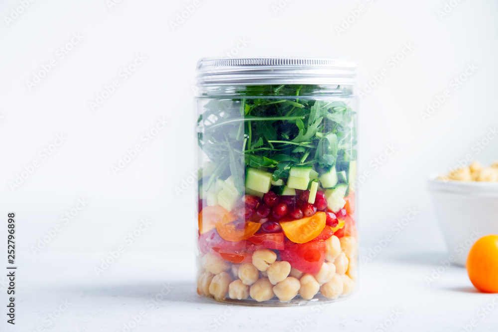 Healthy salad with chickpeas and arugula in a jar. Take away easy lunch concept Healthy salad with chickpeas and arugula in a jar. Take away easy lunch concept