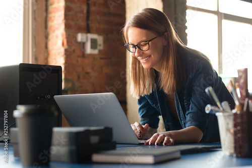 A girl works at a computer in a modern office