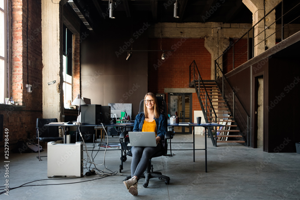 A girl works at a computer in a modern office A girl works at a computer in a modern office