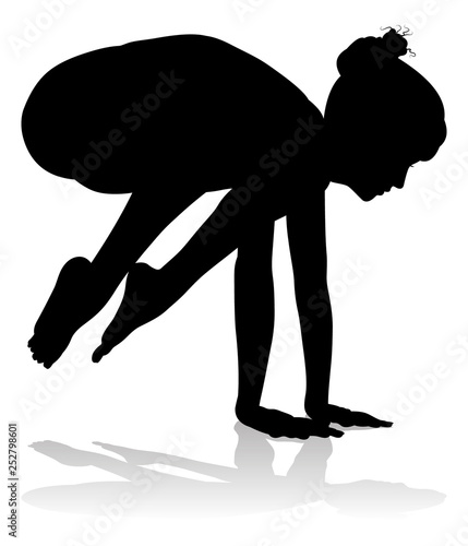 A silhouette of a woman in a yoga or pilates pose 