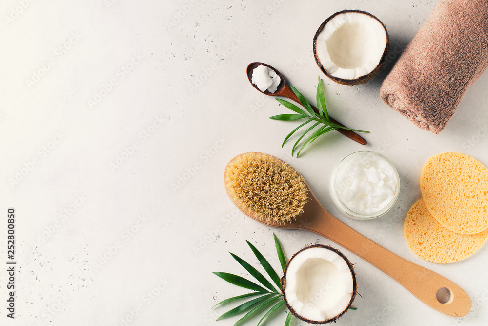 Dry massage brush with coconuts oil, health wellness concept with accessories on white background Dry massage brush with coconuts oil, health wellness concept with accessories on white background