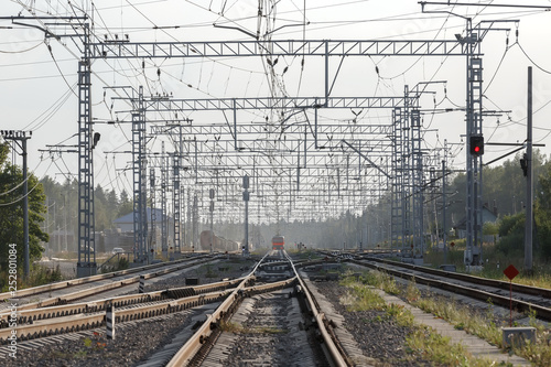 An empty railway sorting station or terminal with lots of junction, crossroads, semaphore showing red or green light