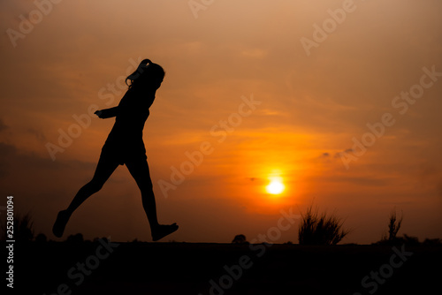 young fitness woman running on sunset seaside trail - Image