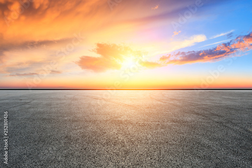 Empty asphalt square ground and city skyline with beautiful clouds at sunset