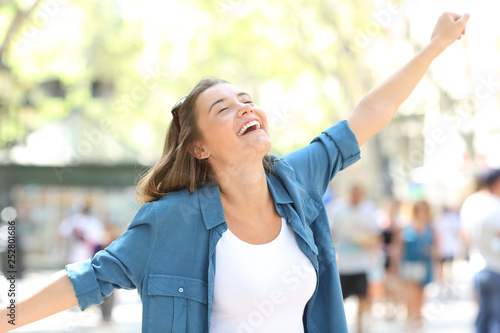 Excited girl celebrating success in the street