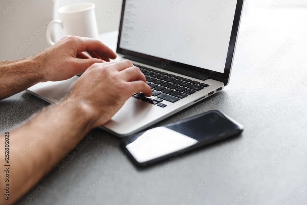 Close up of a man typing on laptop computer Close up of a man typing on laptop computer
