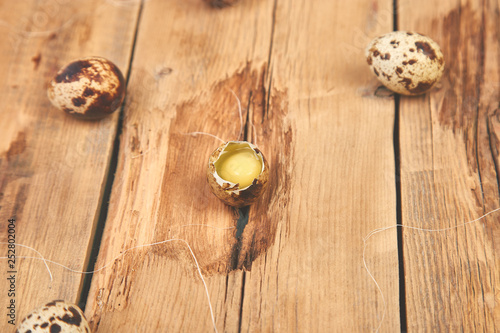 Quail eggs on wooden background. Happy easter.