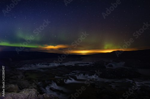 Urridafoss in southern iceland during a night with northern lights, waterfall with aurora 