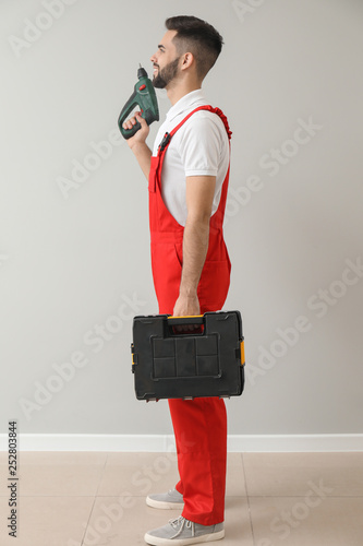 Male worker with drill and ...