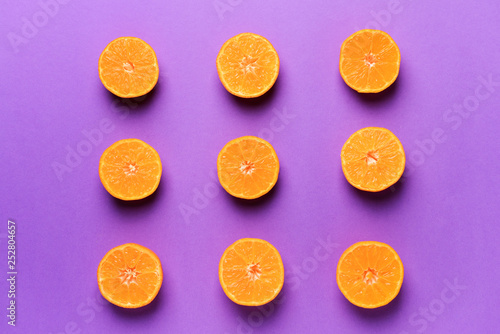 Ripe cut tangerines on color background