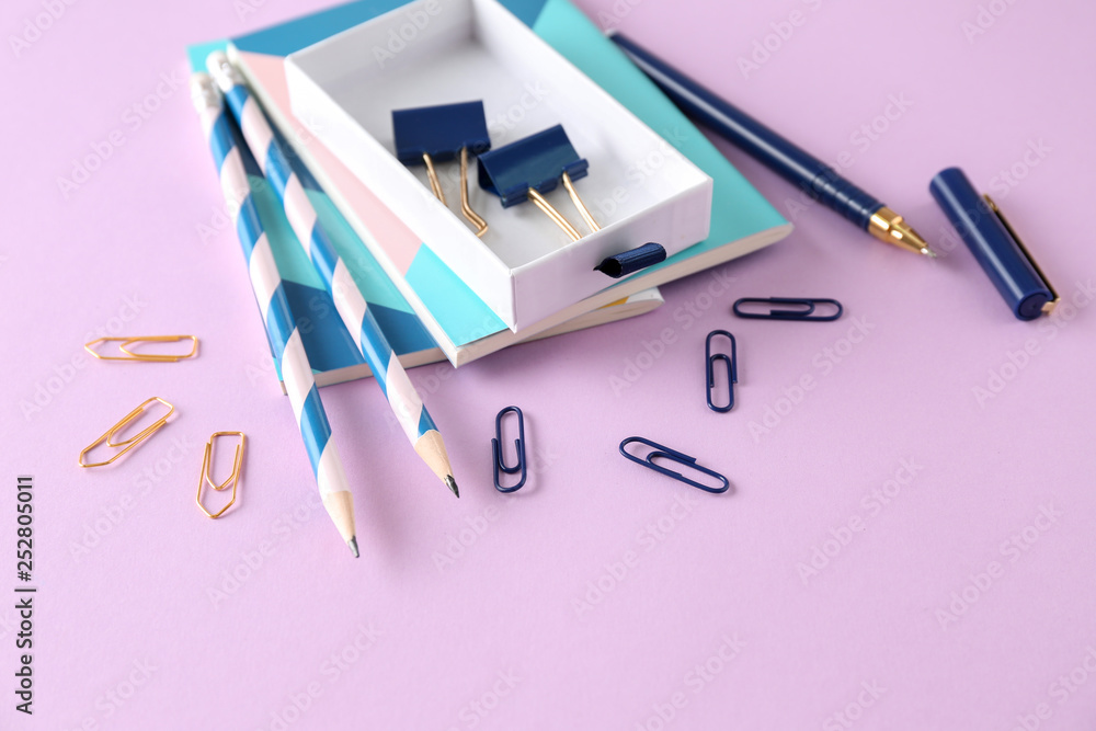 Stylish stationery on color background