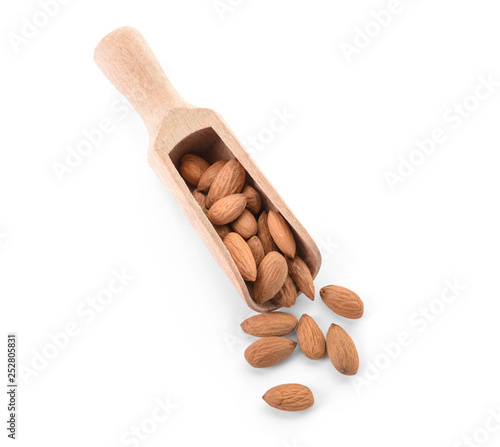 Scoop with tasty almonds on white background