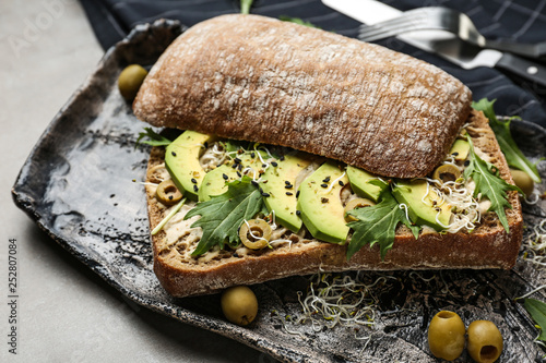 Fresh tasty sandwich on plate, closeup photo