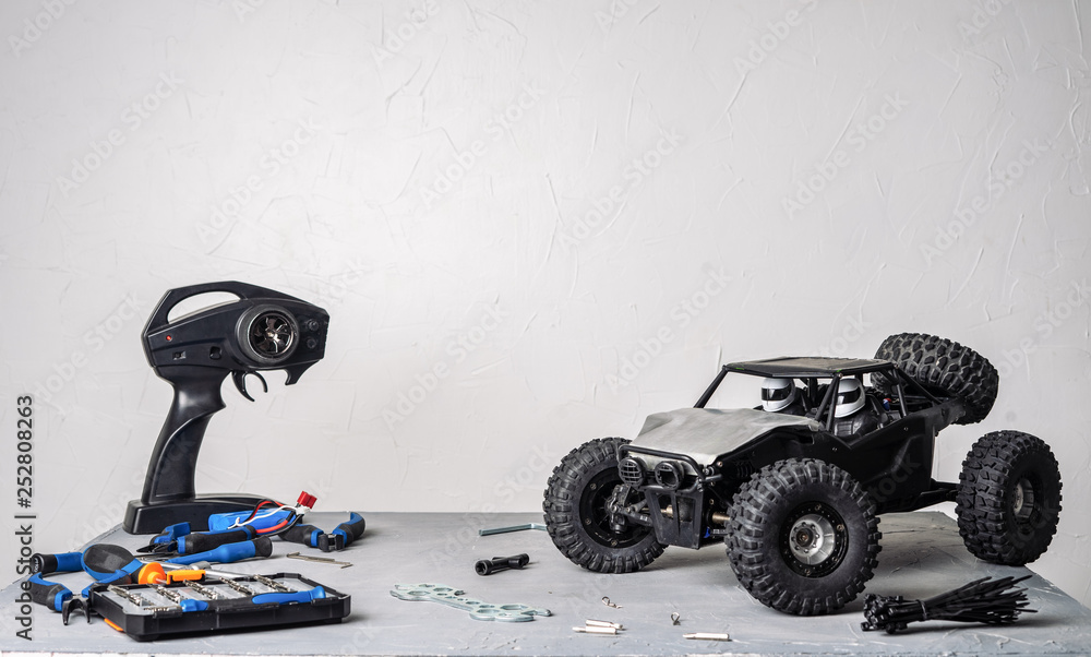 Radiocontrolled car models a table with scattered tools for repairing