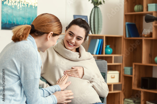 Doula with pregnant woman a...