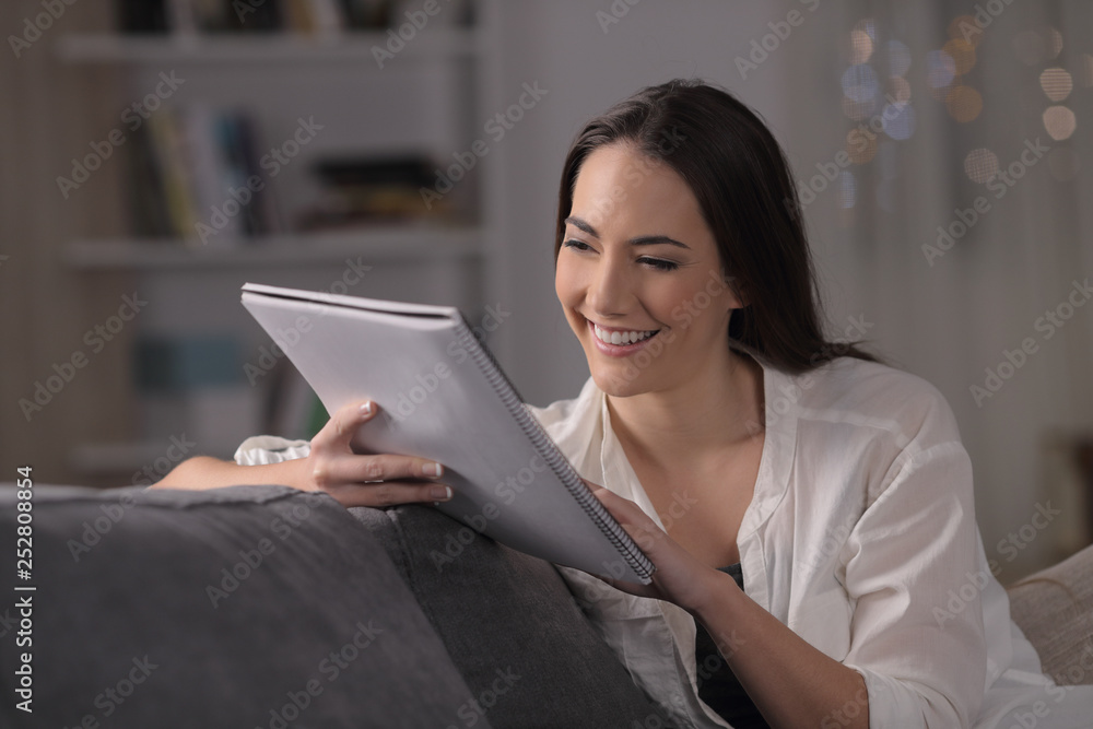 Happy student studying memorizing notes in the night Happy student studying memorizing notes in the night