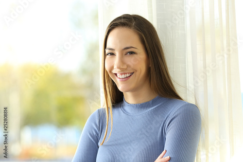 Happy homeowner looking at camera at home