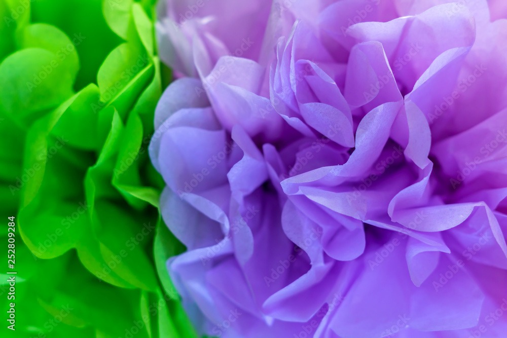 green and purple artificial flowers background texture.