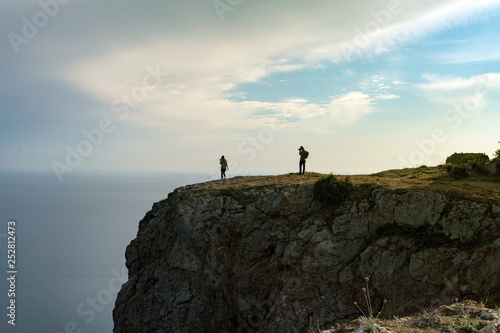 photographer and model on the edge of a cliff © satrap1303