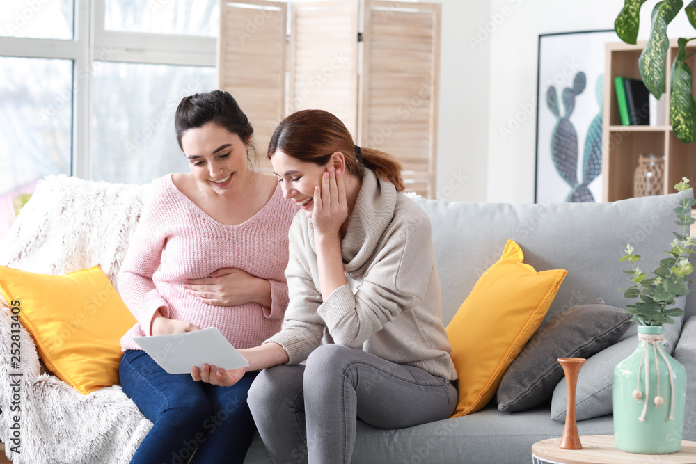 Doula and pregnant woman with ultrasound scans at home Doula and pregnant woman with ultrasound scans at home