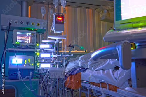 Glowing monitors in intensive care department. Nigth shift at icu, patient in critical state. photo