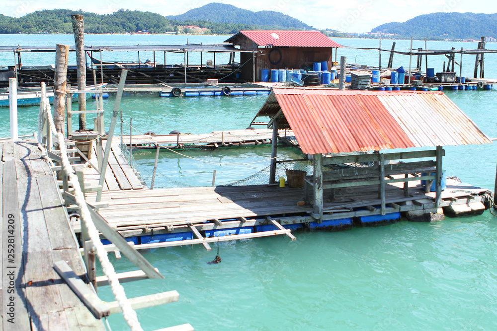 Fishing sea pier in the beautiful turquoise sea and the pier against the background of small islands, Malaysia, Island, the Strait of Malacca, concept of vacation, travel.