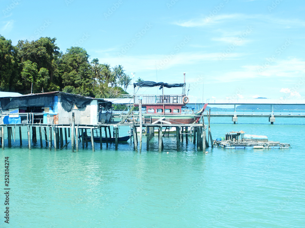 Romantic seascape in a beautiful bay, wooden jetty, Malaysia, island, Malacca Strait, concept of vacation, travel.