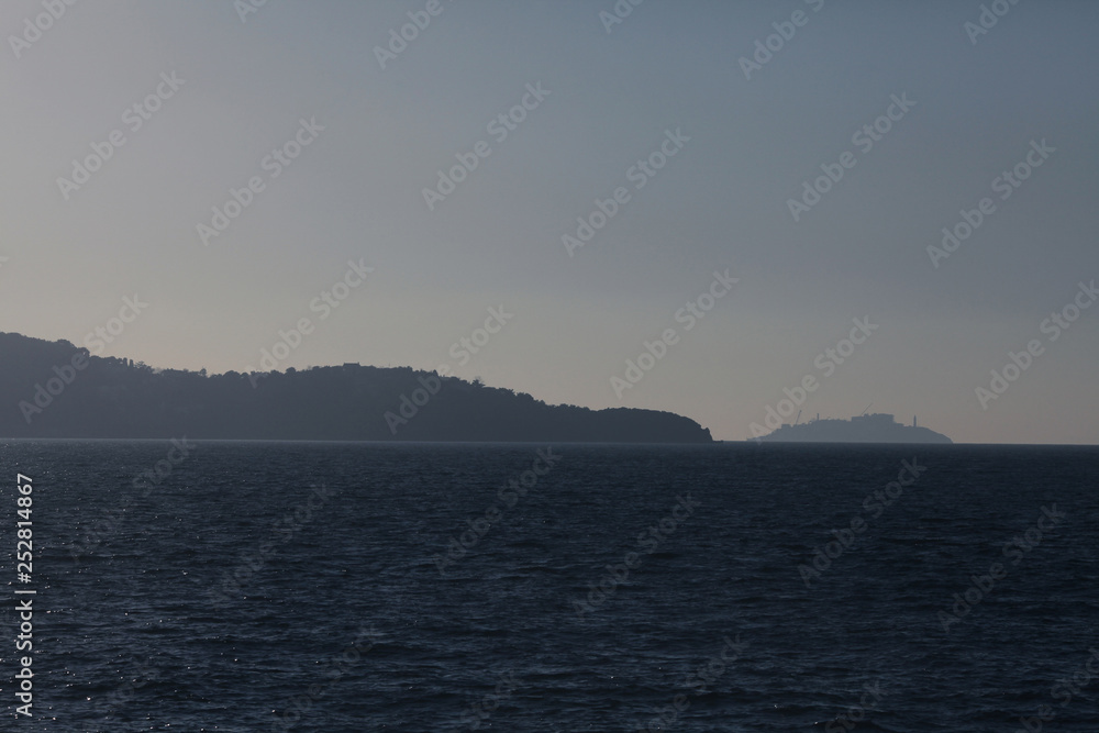 Silhouttes of Turkish Adalar islands in Marmara Sea near Istanbul . Text-space. Minimalism style. Outdoor shot