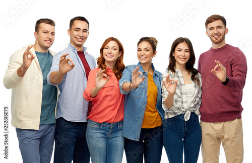 gesture, friendship and people concept - group of smiling friends showing ok hand sign over white background